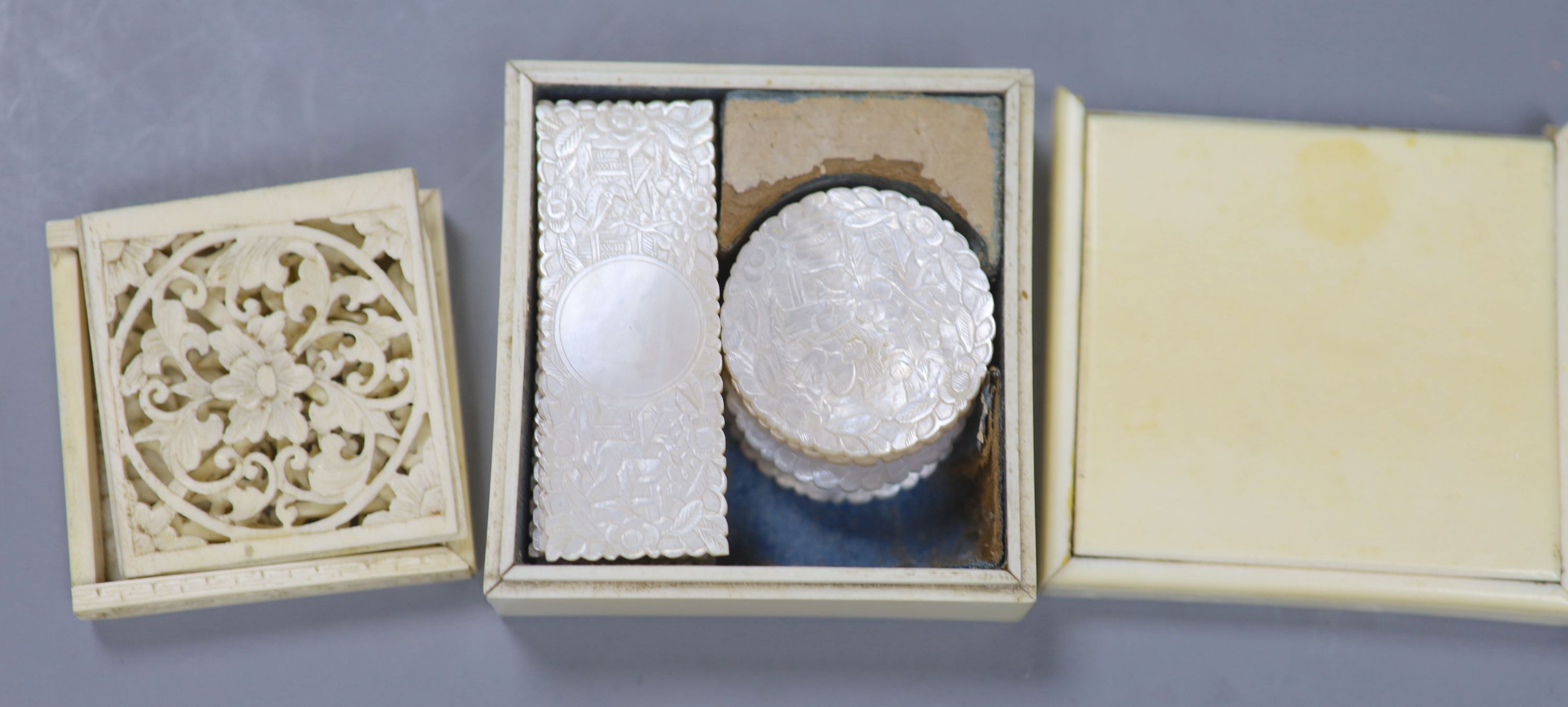 A 19th century ivory box containing a collection of fourteen Chinese carved mother-of-pearl gaming tokens, together with a 19th century